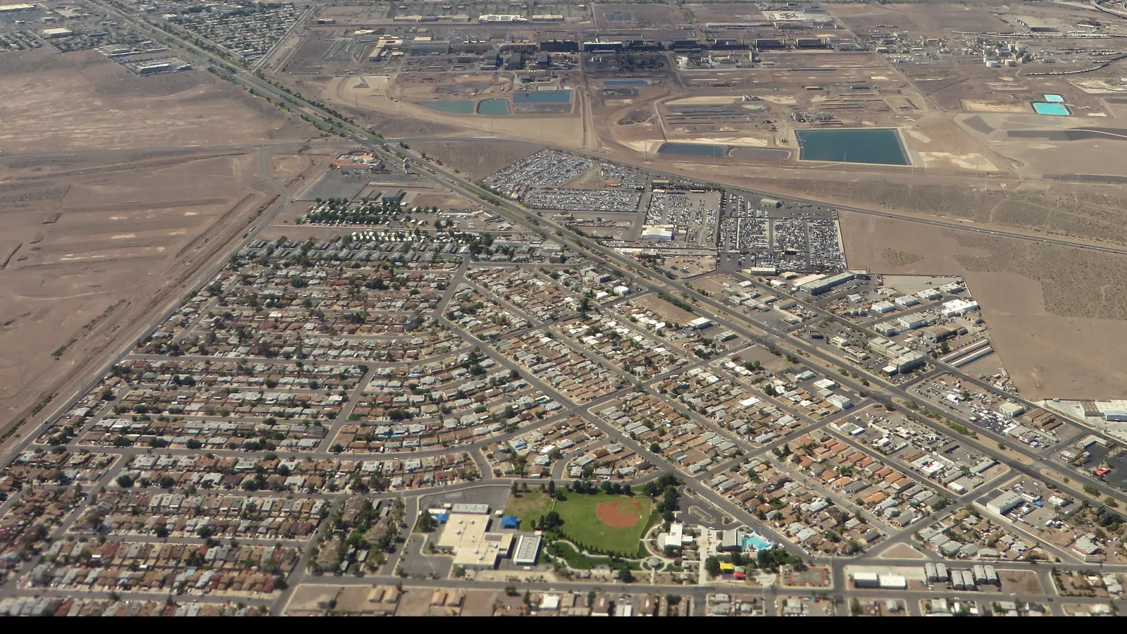 Aerial view of a dense residential area and open desert at the edge of the Las Vegas valley