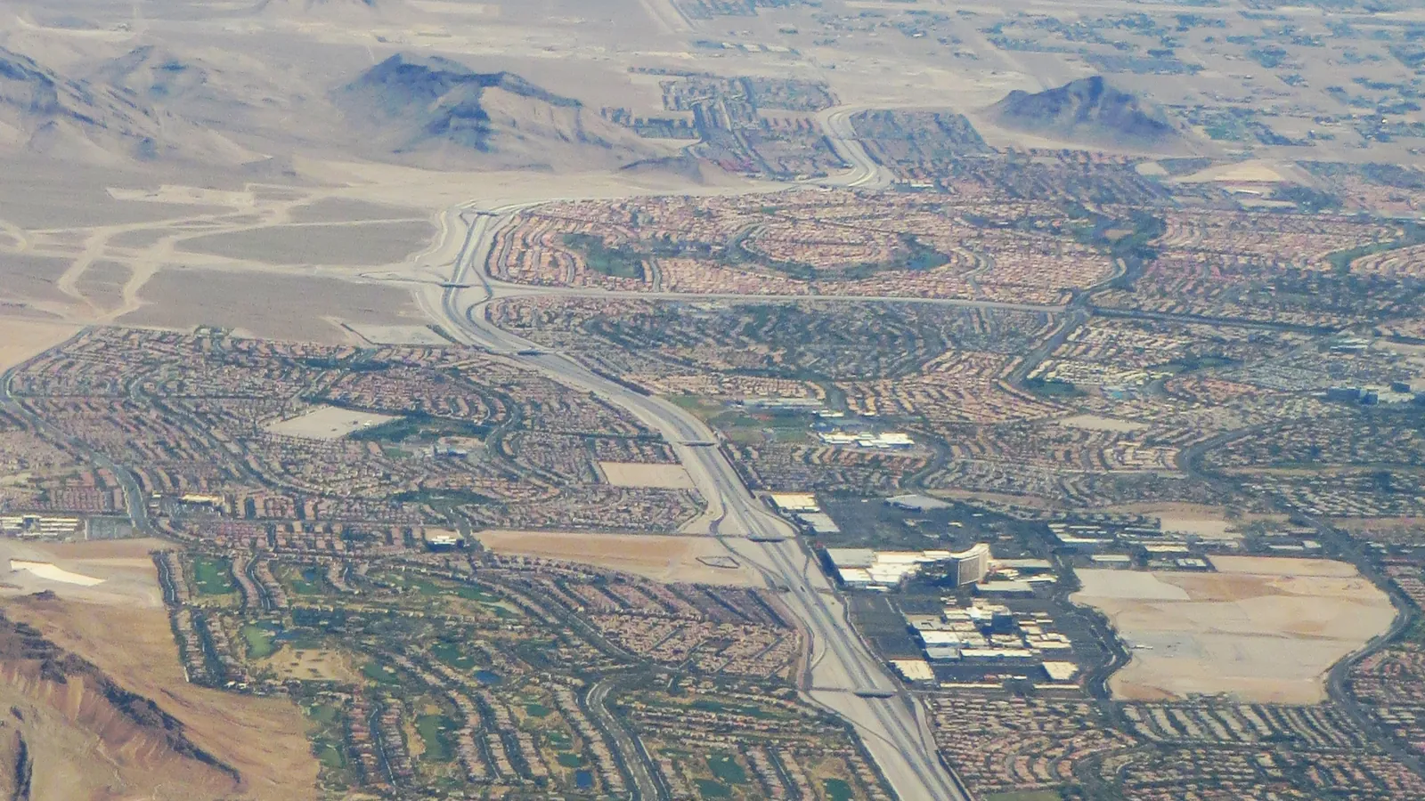 Aerial view of residential streets and homes spreading across desert hills in Summerlin, Las Vegas