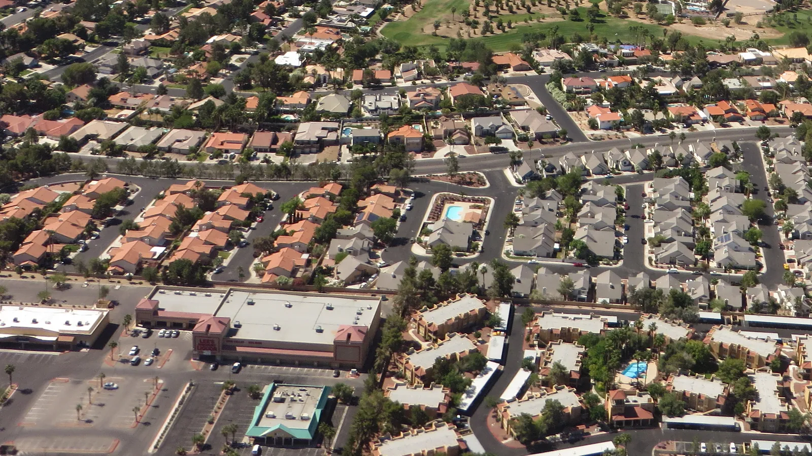 Aerial view of neighborhoods of closely spaced homes and streets in the Las Vegas valley
